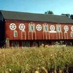 A classic red barn in a rural American landscape, illustrating the traditional color choice for farm buildings and the enduring presence of red barns in agricultural settings.