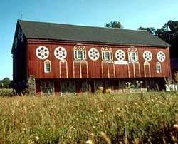 A classic red barn in a rural American landscape, illustrating the traditional color choice for farm buildings and the enduring presence of red barns in agricultural settings.