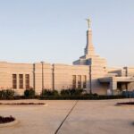 A serene Mormon Temple bathed in sunlight, symbolizing faith and tradition.