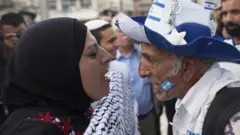 A visual representation of the Israeli-Palestinian conflict, showing a pro-Palestinian woman confronting a pro-Israel supporter during a demonstration. This image encapsulates the deep divisions and ongoing tensions in the region, highlighting the opposing viewpoints that fuel the long-standing war.