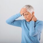 A woman experiencing a headache after eating.