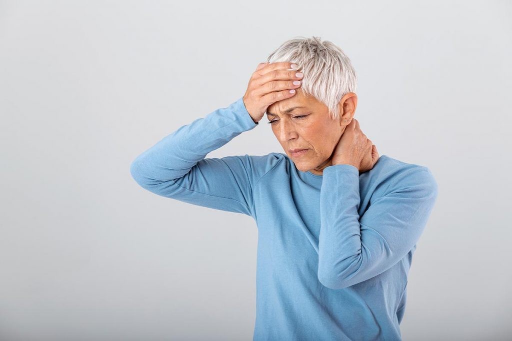 A woman experiencing a headache after eating.