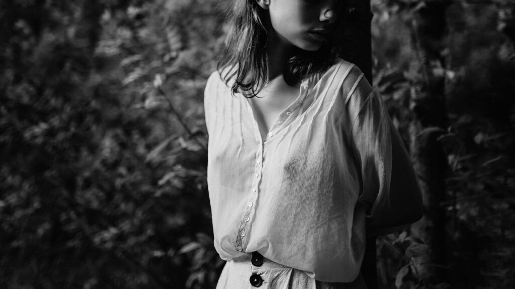 A woman walking in the forest wearing a white shirt -1.