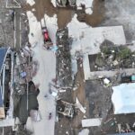 Aerial view of debris clearing in Asheville, NC after Hurricane Helene flooding.