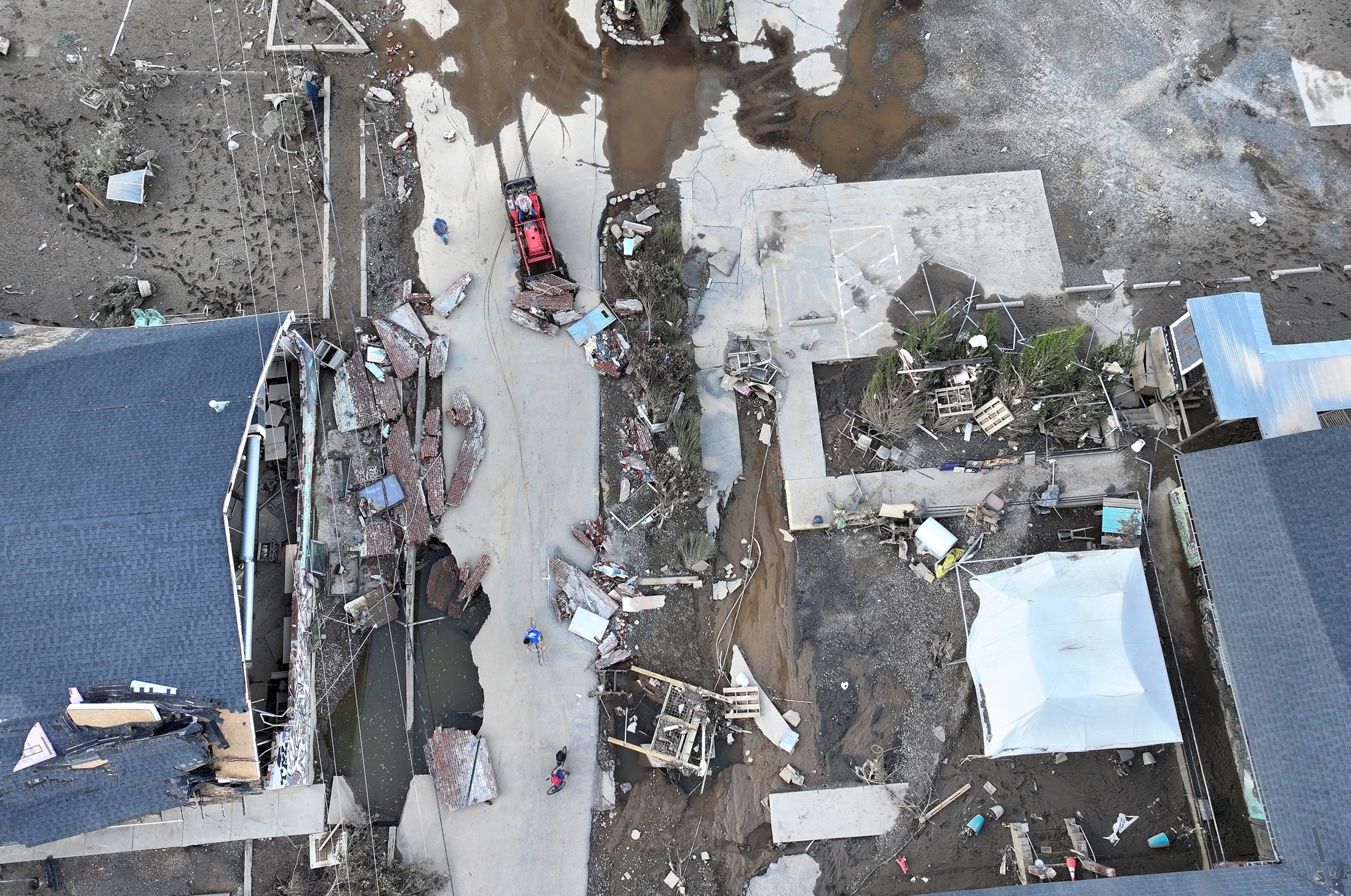 Aerial view of debris clearing in Asheville, NC after Hurricane Helene flooding.