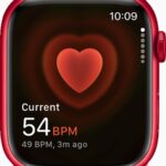 An Apple Watch displaying a heart rate of 54 beats per minute on its screen.