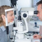 An optometrist examines his patient