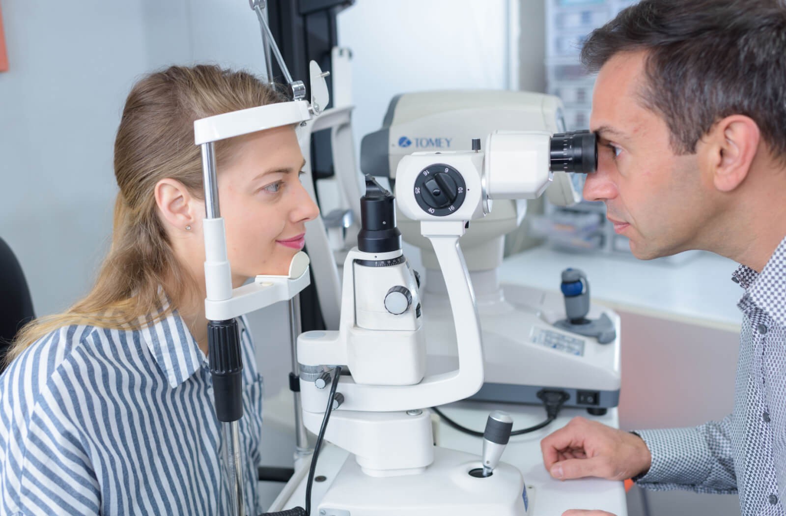 An optometrist examines his patient