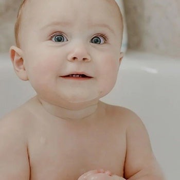 Baby with rosy cheeks looking at the camera