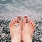 Bare feet of a woman lying on a wooden floor