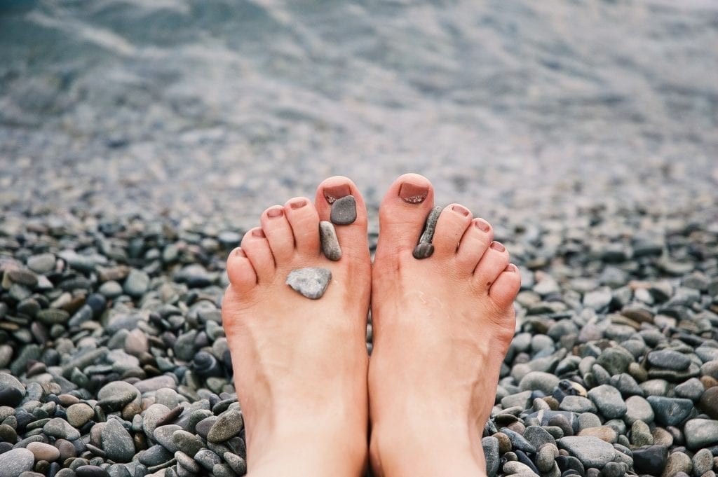 Bare feet of a woman lying on a wooden floor