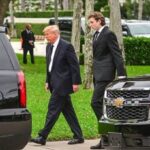 Barron Trump towering over Donald Trump, highlighting the significant height difference between father and son.