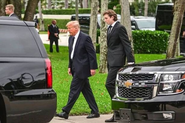 Barron Trump towering over Donald Trump, highlighting the significant height difference between father and son.