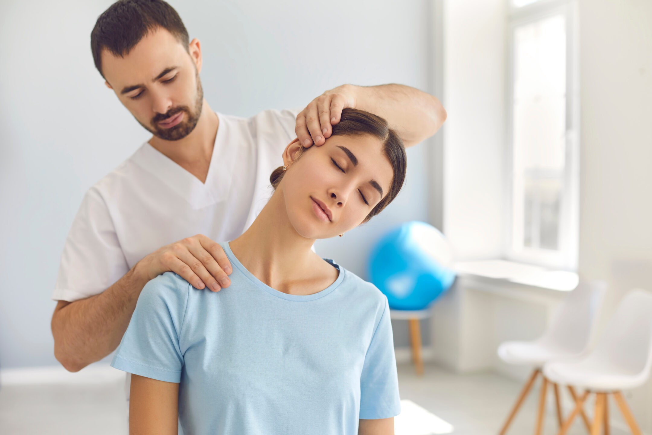 Chiropractor carefully adjusts a patient's neck to relieve pain and improve spinal alignment.