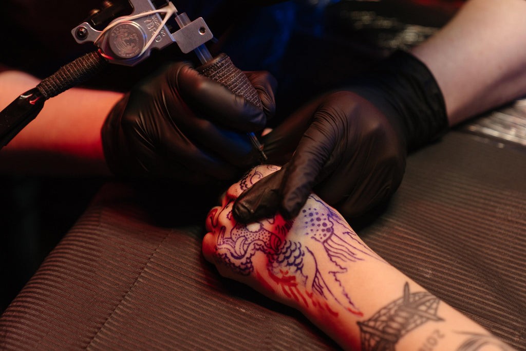 Close-up of a newly done tattoo on a person's arm, showcasing the vibrant colors and fresh ink