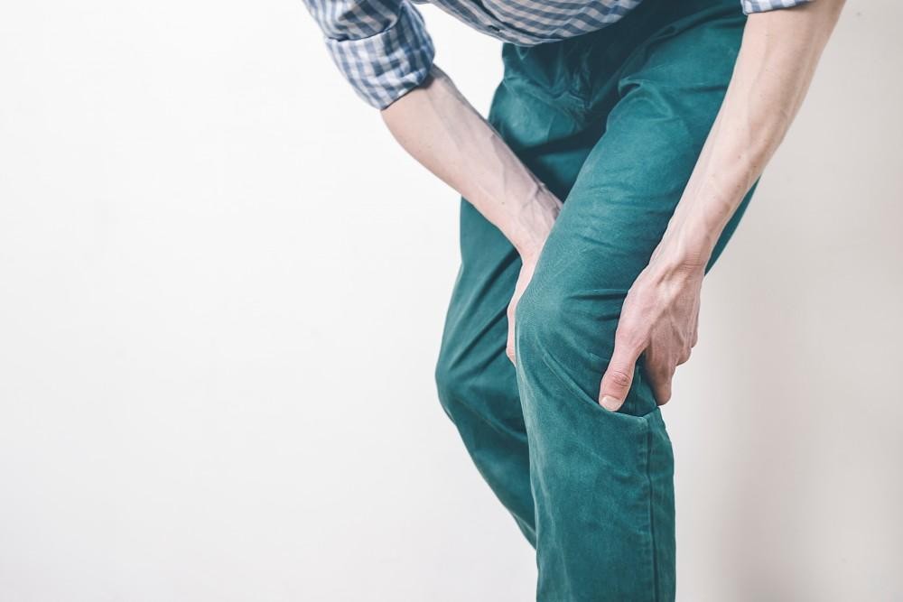 Close-up of legs showing varicose veins, illustrating potential causes of heavy legs