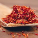 Close-up of vibrant red saffron threads, showcasing the spice's intense color and delicate strands