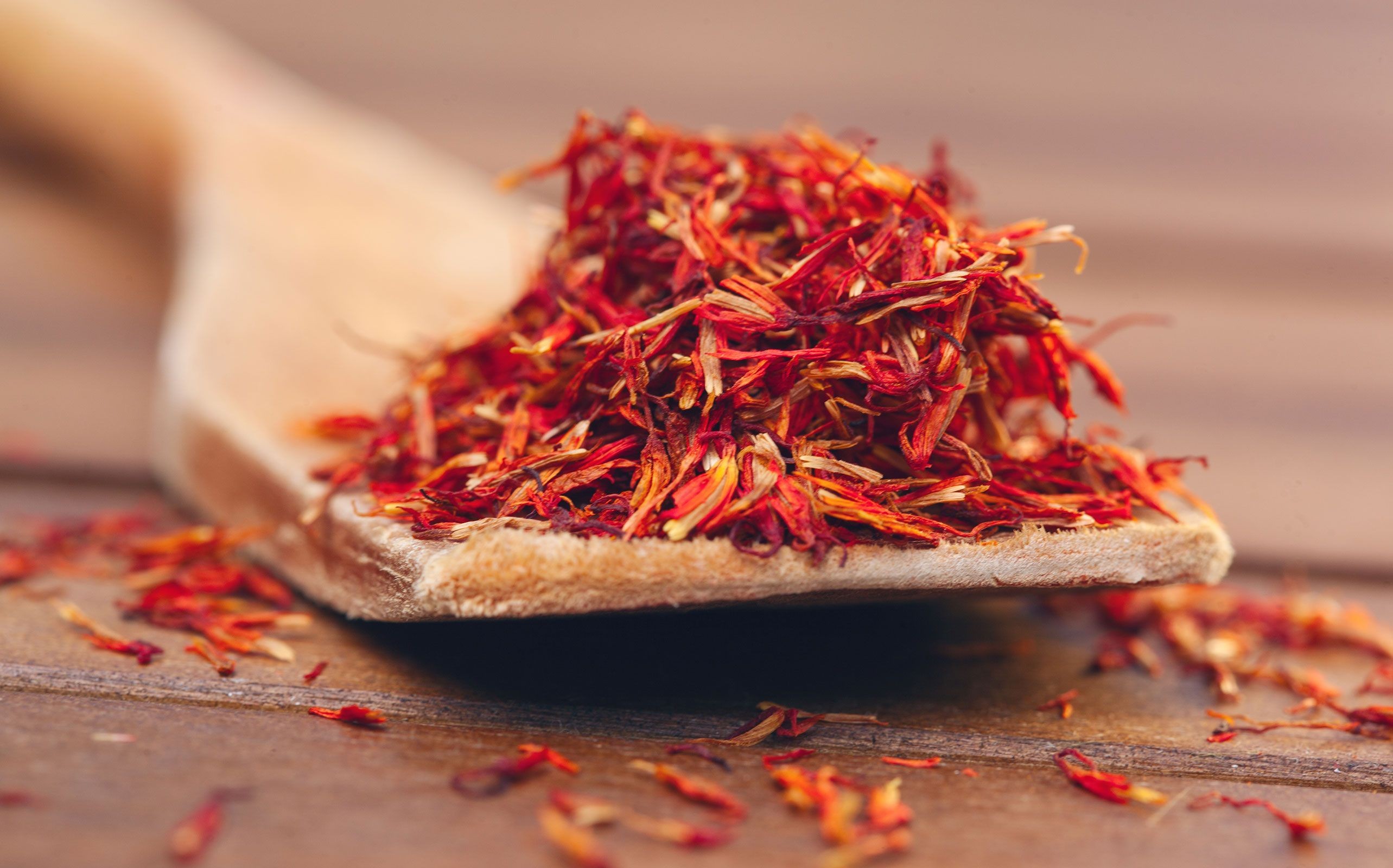 Close-up of vibrant red saffron threads, showcasing the spice's intense color and delicate strands