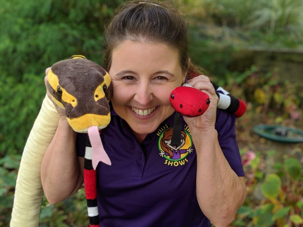 CobraCaroline engaging preschoolers with a snake puppet show, making learning fun and accessible