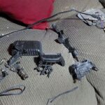 Debris of exploded walkie-talkies used by Hezbollah, showcasing the aftermath of targeted attacks on their low-tech communication devices.