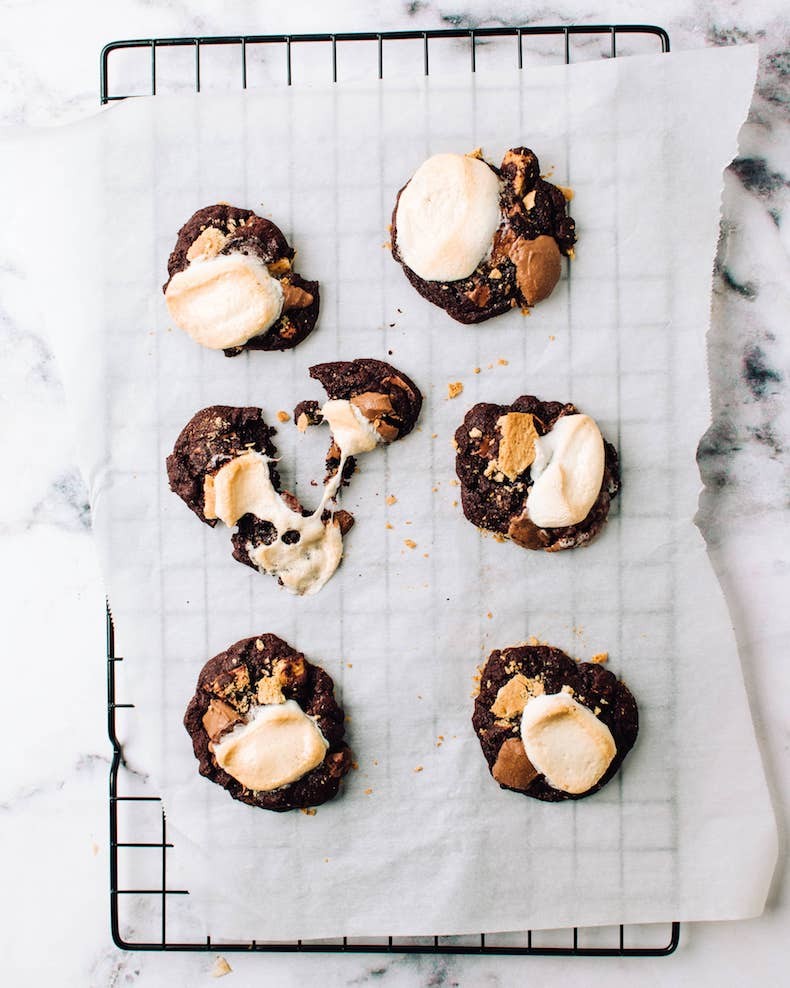 Disappointingly flat cookies on a baking sheet, a common baking problem caused by butter melting too quickly.