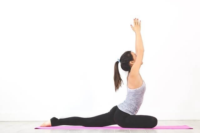 Diverse group stretching outdoors, illustrating the feel-good sensation and benefits of stretching for overall well-being.