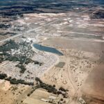 Early aerial view of Six Flags Over Texas amusement park, showcasing its original layout amidst the vast Texas landscape.