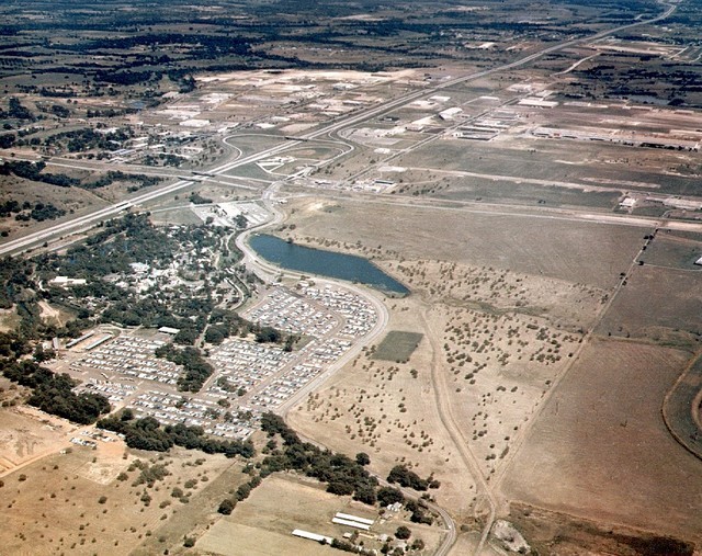 Early aerial view of Six Flags Over Texas amusement park, showcasing its original layout amidst the vast Texas landscape.