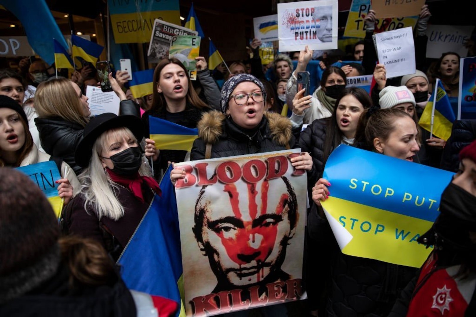 Global Protest Against Russia's War in Ukraine: Demonstrators in Istanbul holding Ukrainian flags and signs condemning the invasion.