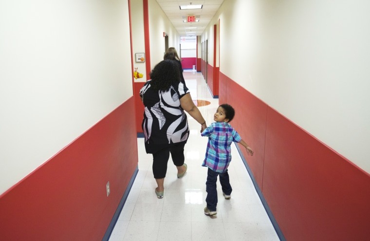 Marlaina Dreher walks with her son Brandon, alt text: Marlaina Dreher Guides Her Son Brandon at Marcus Autism Center