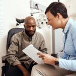 Optometrist explaining stye prevention and eyelid hygiene to a patient during an eye exam, addressing concerns about recurring styes.