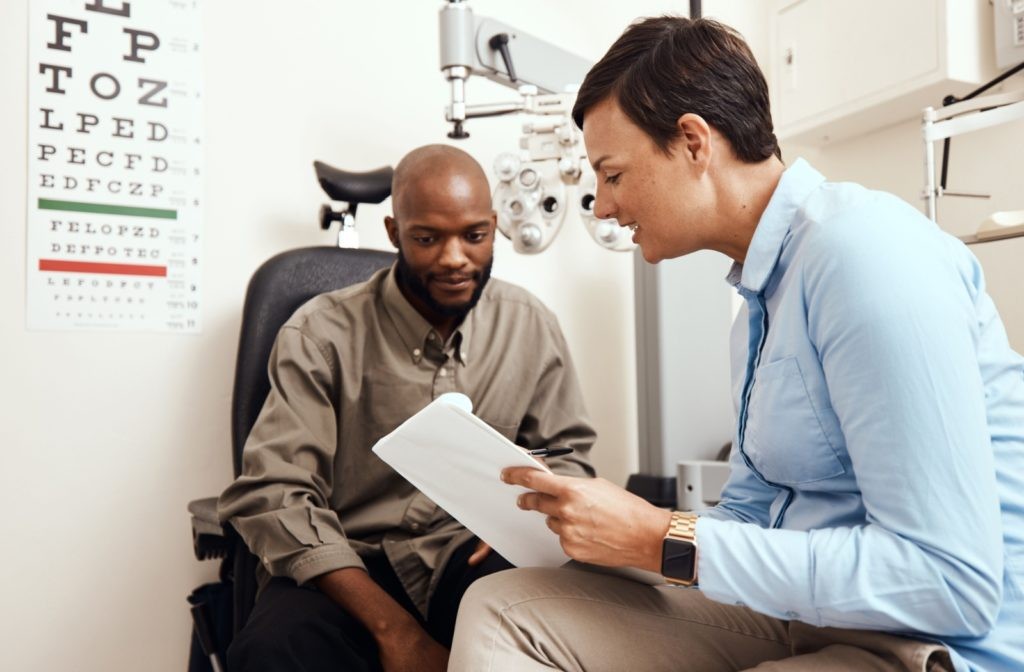 Optometrist explaining stye prevention and eyelid hygiene to a patient during an eye exam, addressing concerns about recurring styes.