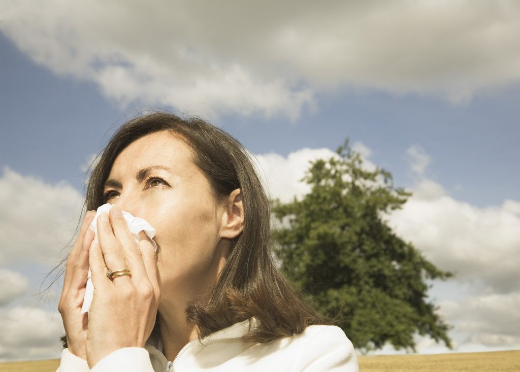 Person sneezing in bright sunlight.