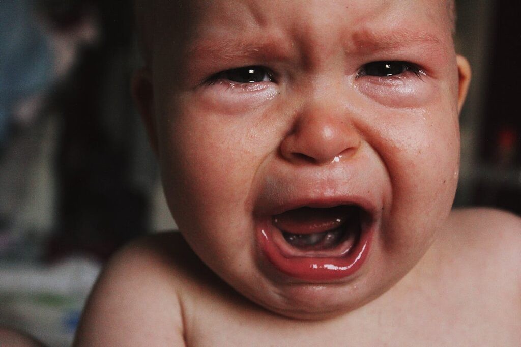 portret of a baby screaming and crying