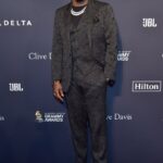 Sean Diddy Combs smiles in a black suit at the Grammy Awards