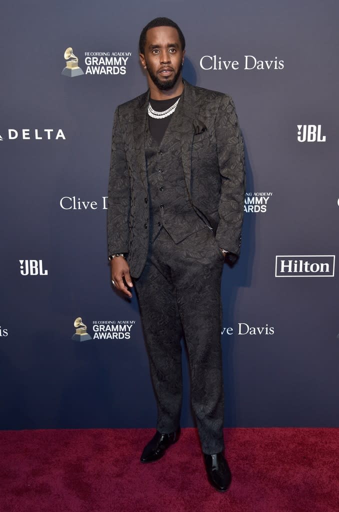 Sean Diddy Combs smiles in a black suit at the Grammy Awards