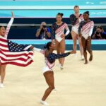 Simone Biles, the GOAT of gymnastics, celebrates with her US women's gymnastics team after winning gold at the Paris 2024 Olympics.