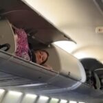 Southwest Airlines passenger in overhead bin amidst flight disruptions