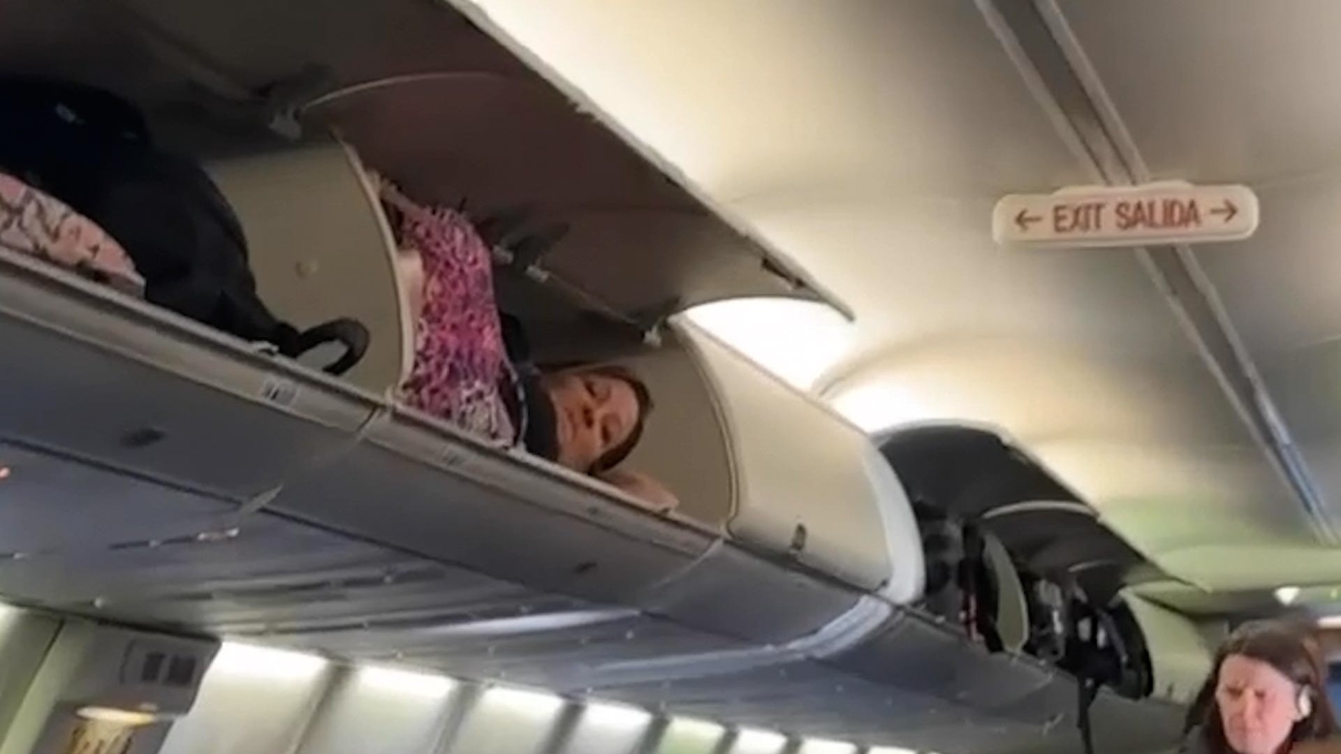 Southwest Airlines passenger in overhead bin amidst flight disruptions