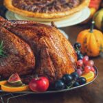 Thanksgiving turkey dinner with mashed potatoes, stuffing, and other side dishes.