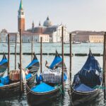 Venice cityscape featuring canals and historic buildings, illustrating the city's vulnerability to sinking and rising sea levels.