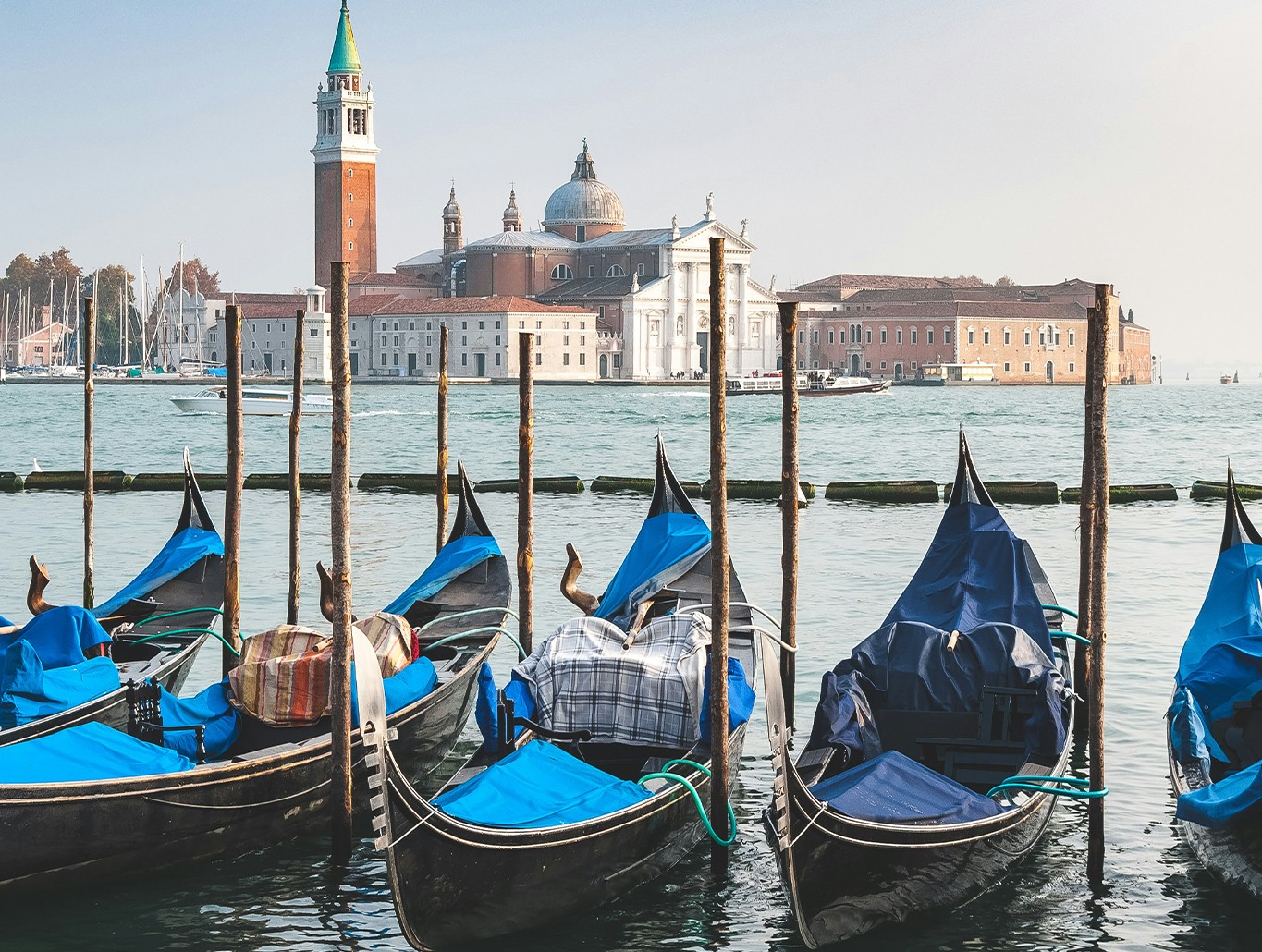 Venice cityscape featuring canals and historic buildings, illustrating the city's vulnerability to sinking and rising sea levels.