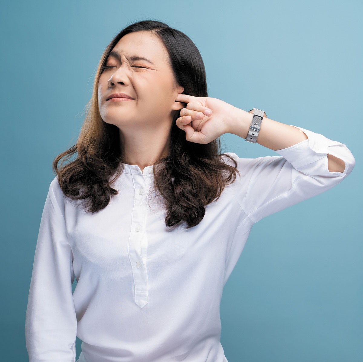 Woman Demonstrates Ear Plugging Sensation, a Common Cause of Muffled Hearing