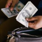 Woman happily holding bonus check