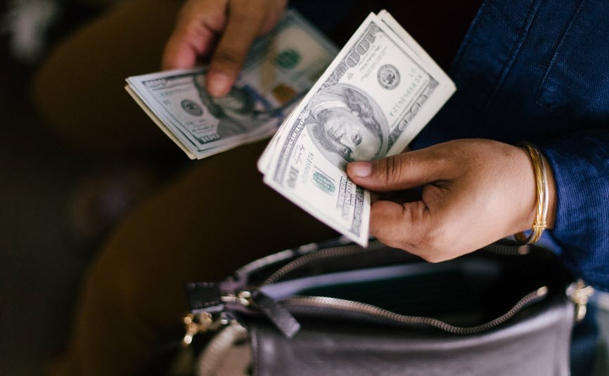 Woman happily holding bonus check