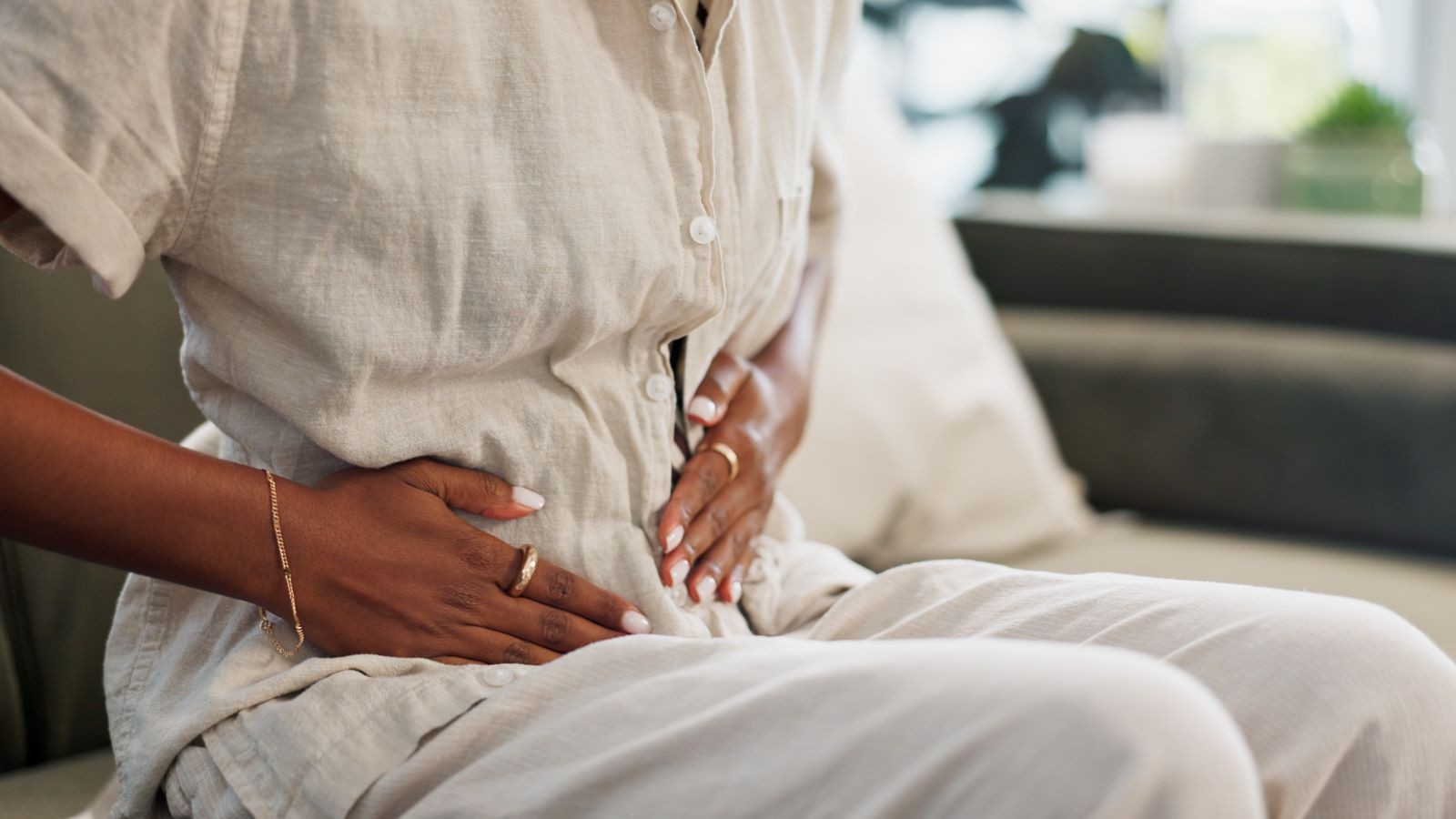 Woman holding stomach in pain, representing bloating after eating