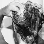 Woman washing hair to illustrate scalp care