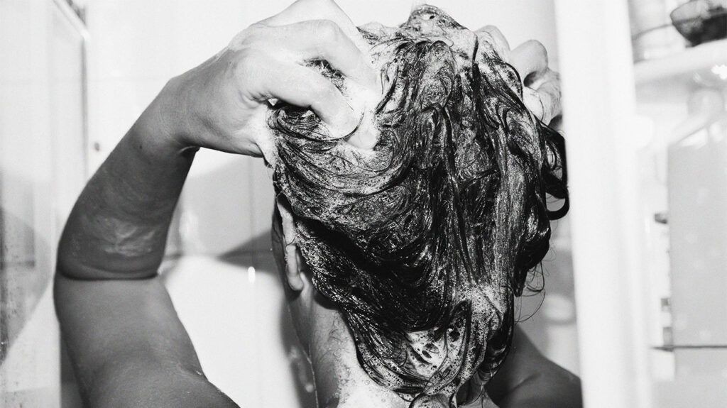 Woman washing hair to illustrate scalp care