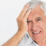 Worried senior man experiencing severe headache pain