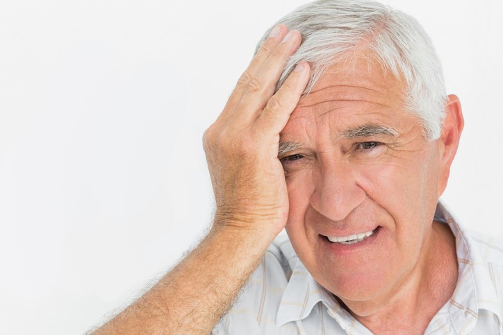 Worried senior man experiencing severe headache pain